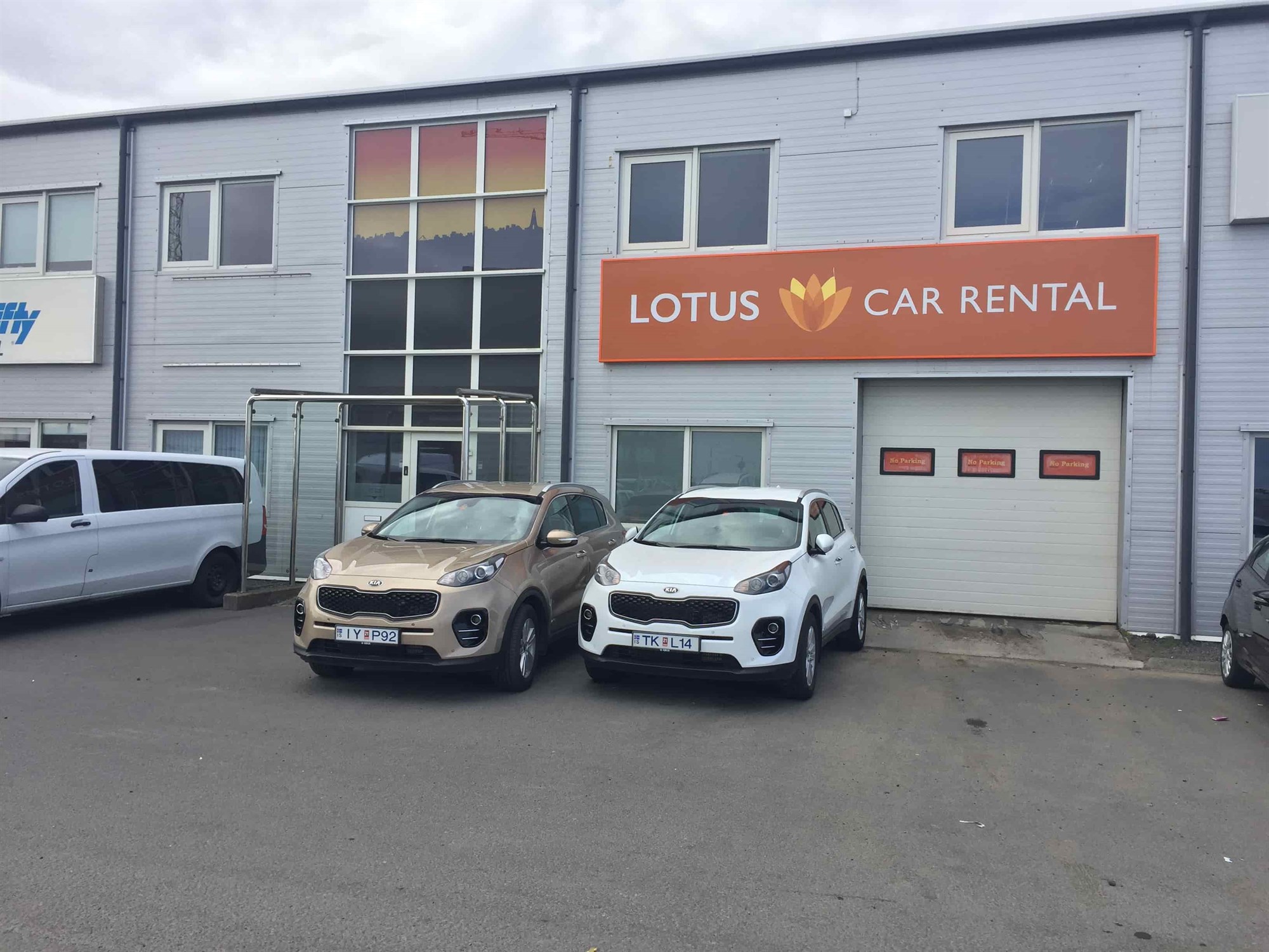 lotus car rental office with two kia sportage rental cars