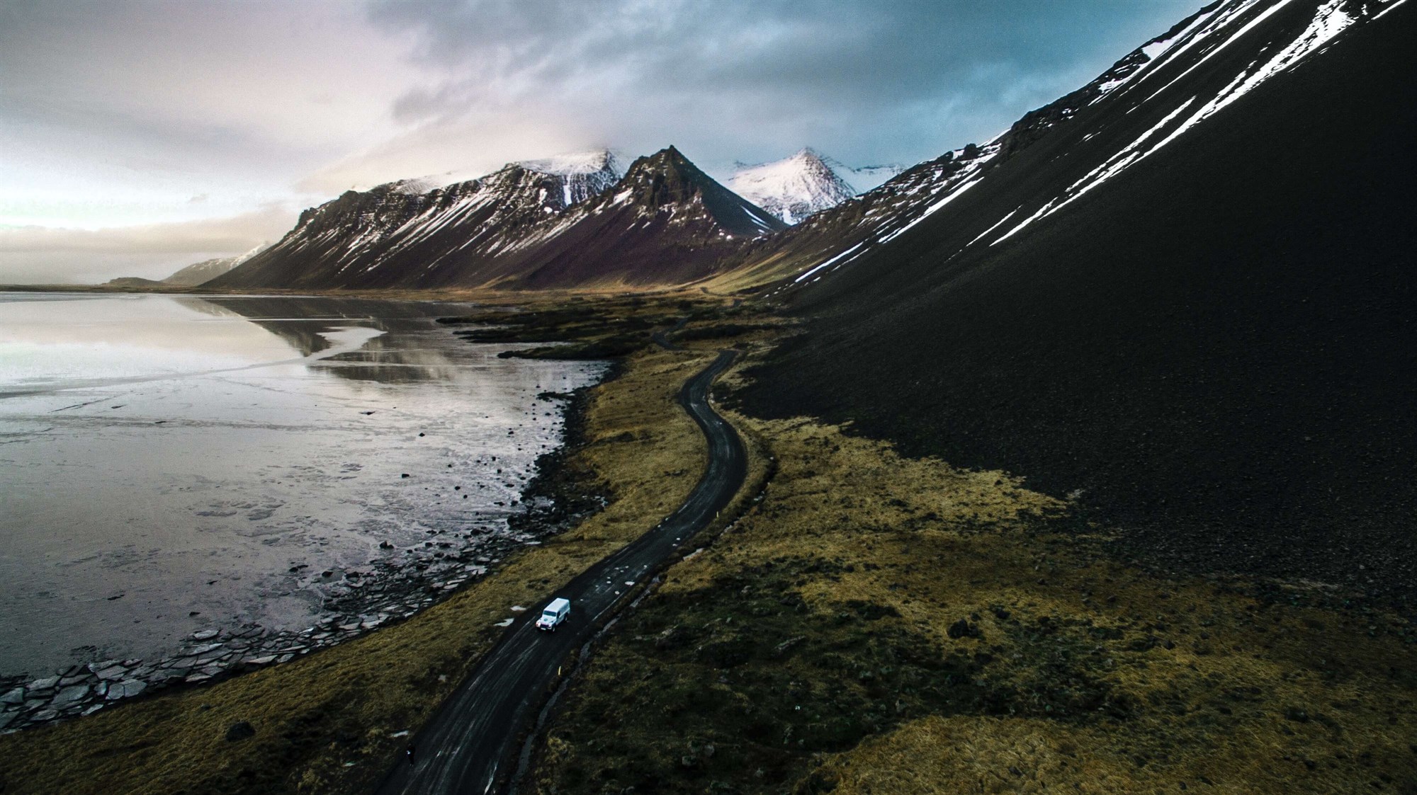 Aerial shot of road along volcanic mountains at Stokksnes black beach