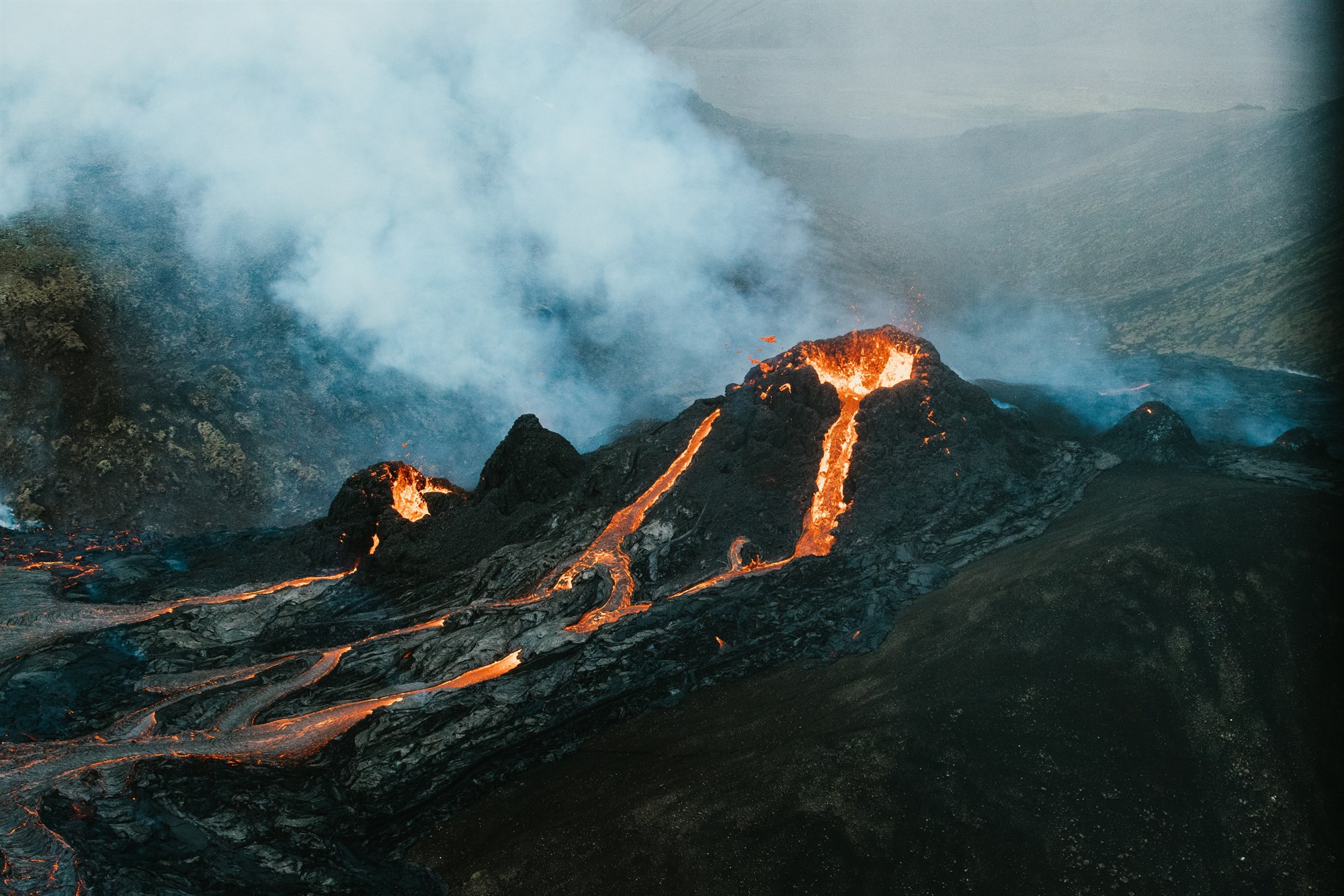 An erupting volcano with flowing lava in Iceland