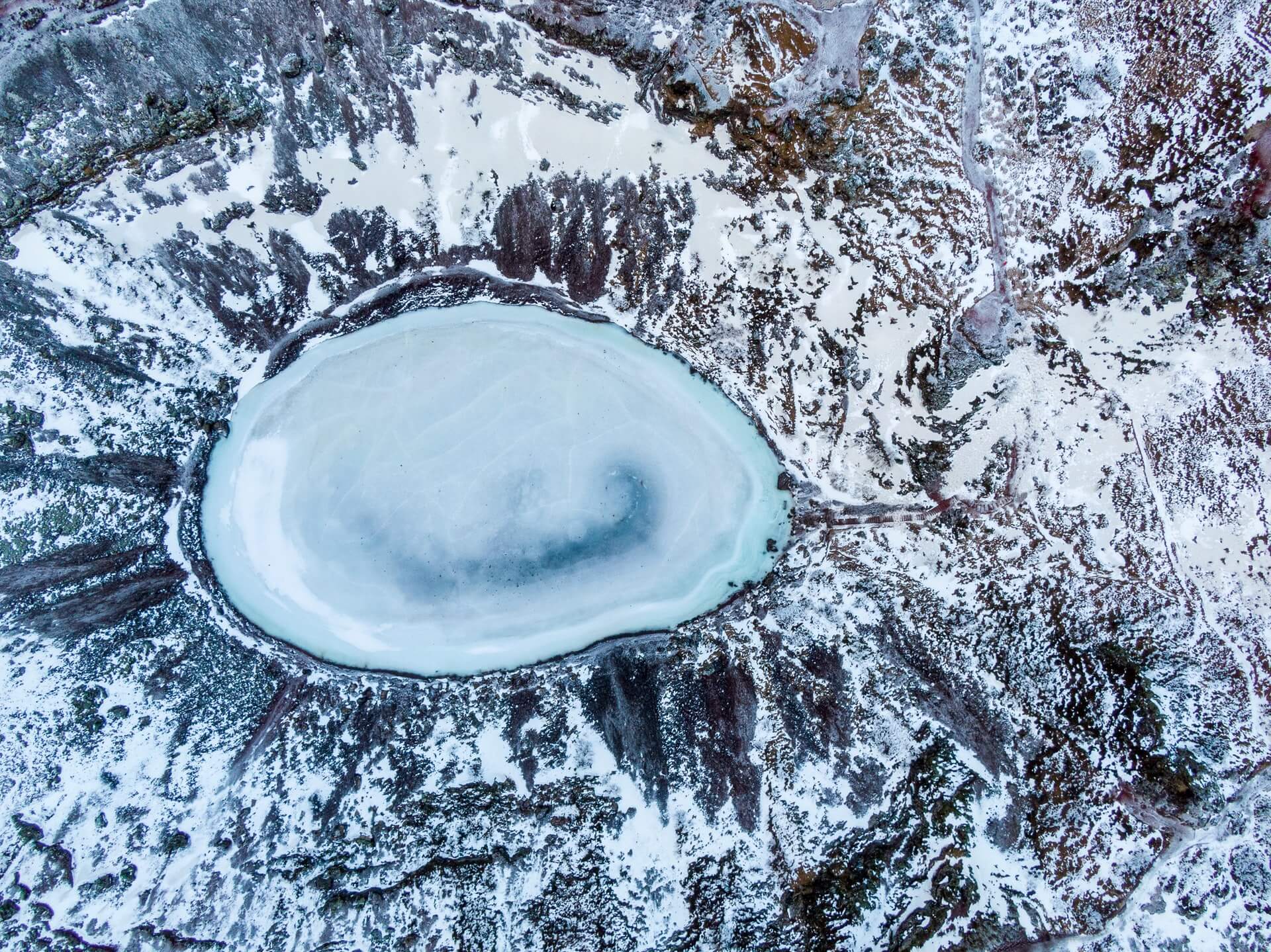 An aerial image of the Kerid crater frozen. 