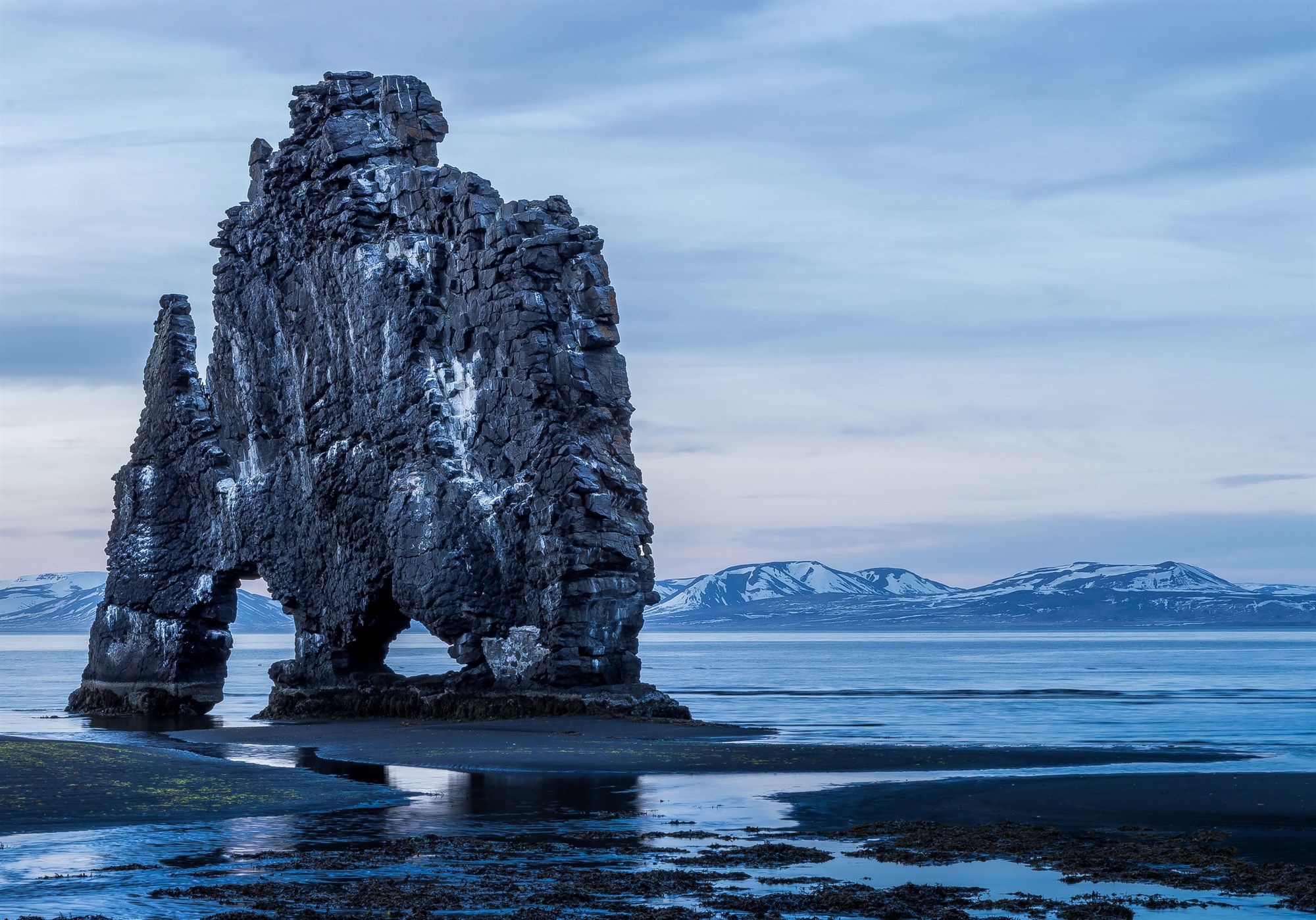 Hvítserkur rock in front of snow covered mountains