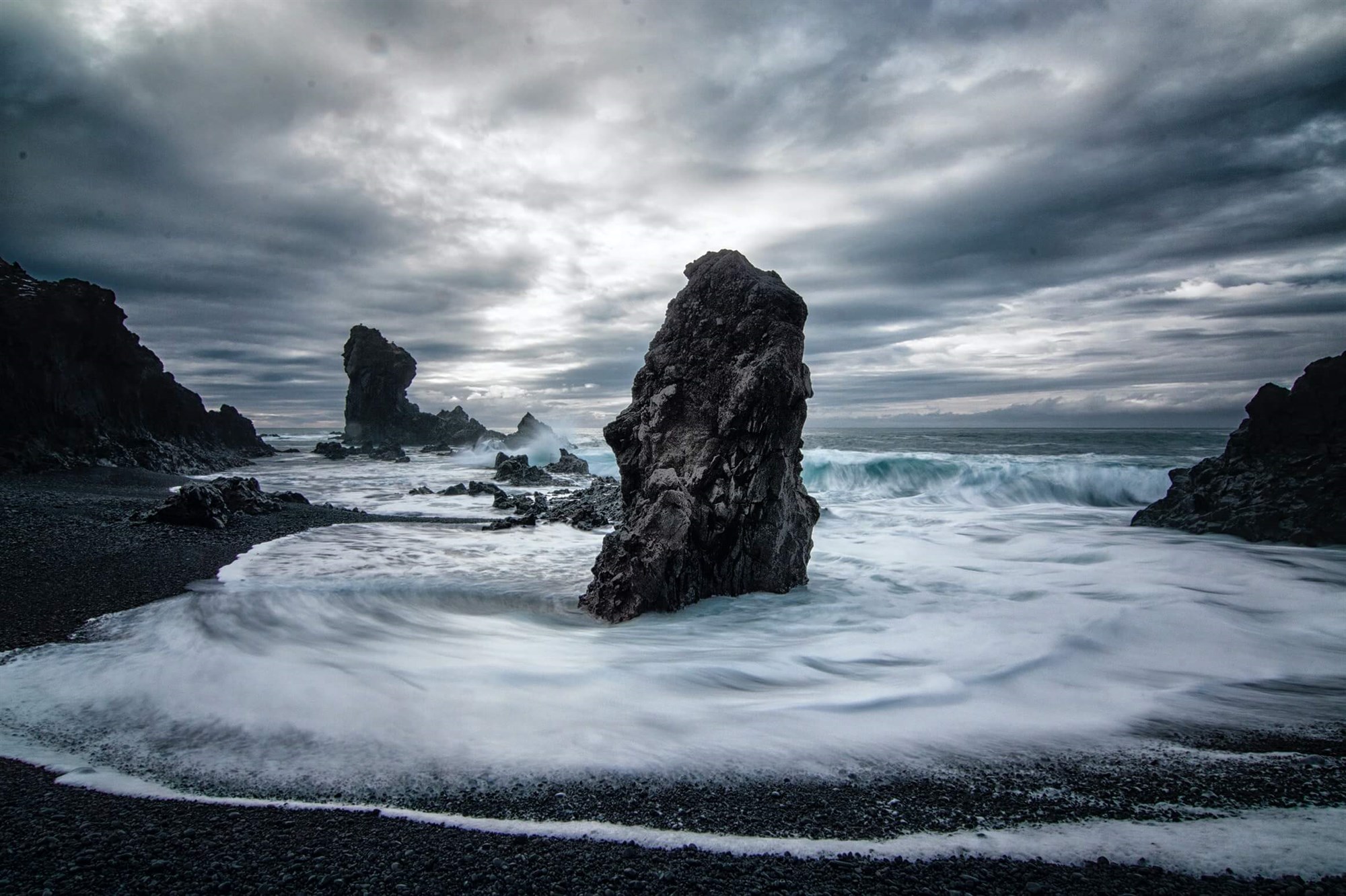 Powerful waves crashing on the shore at Djúpalónssandur black beach in Iceland 