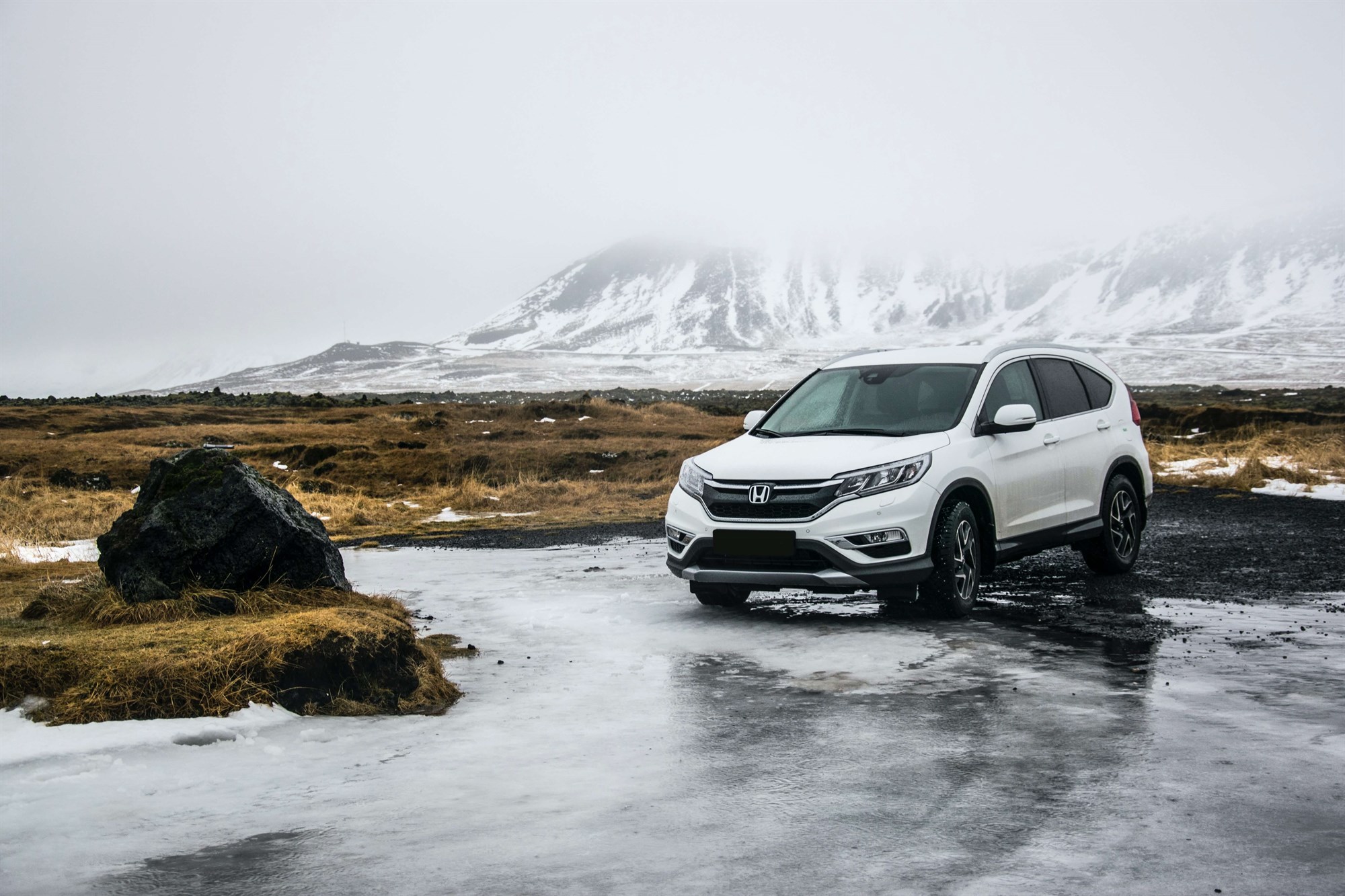 White SUV crossing a river in Snæfellsbær, Iceland